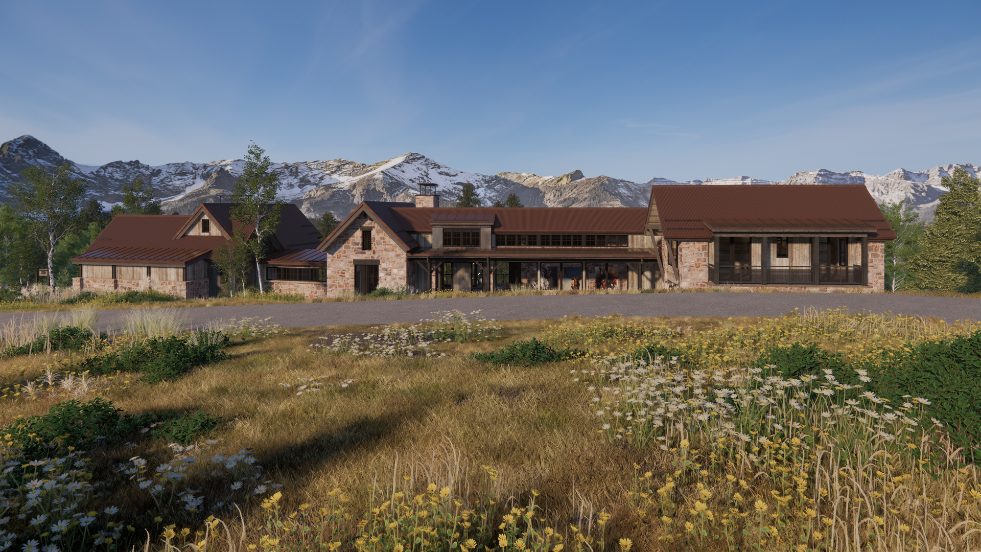 A large house is sitting in the middle of a field with mountains in the background.