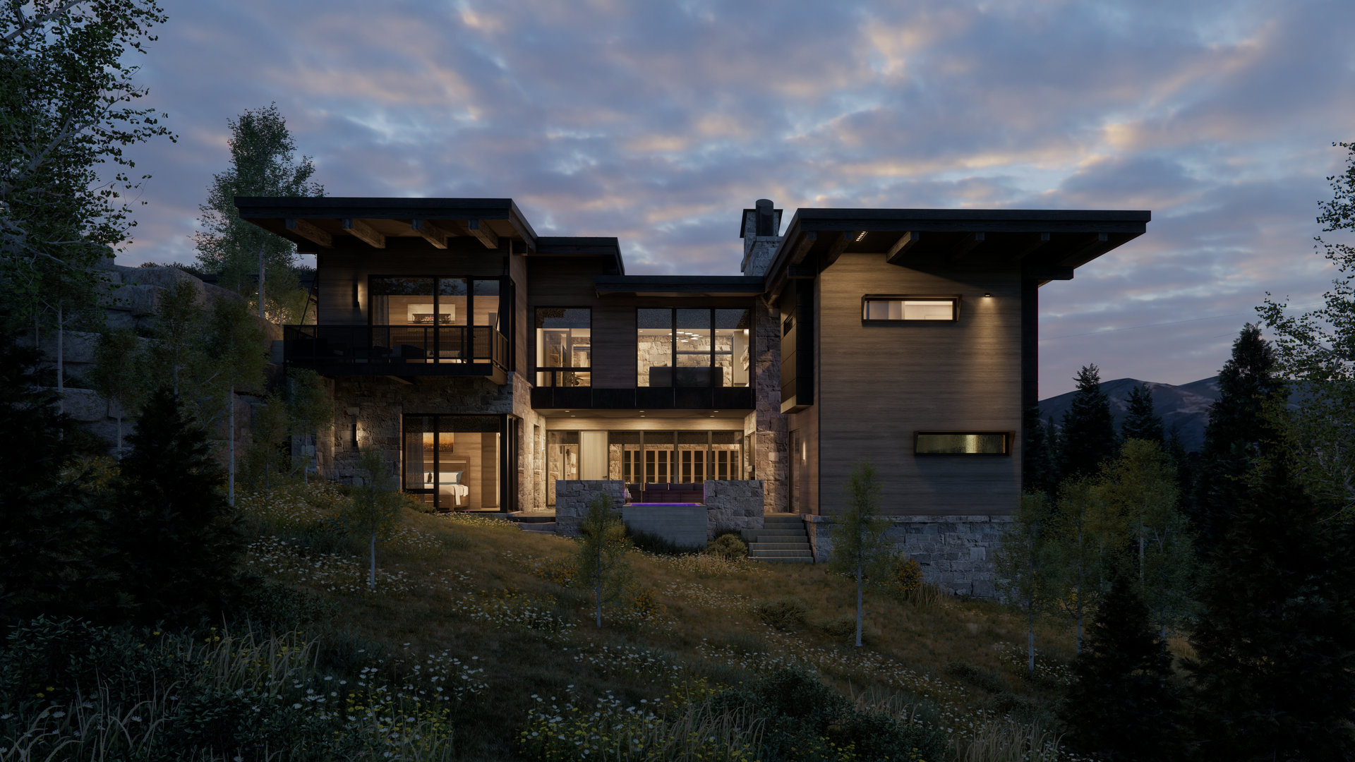 A large house is sitting on top of a hill at night surrounded by trees.