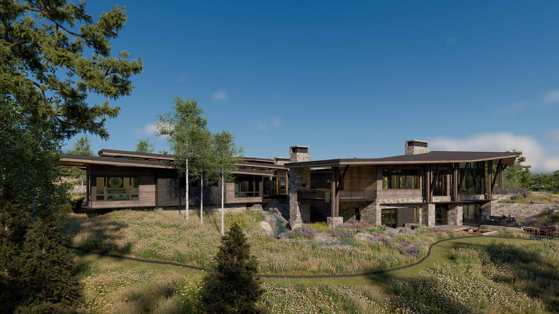 A large house is sitting on top of a hill in the middle of a field surrounded by trees.