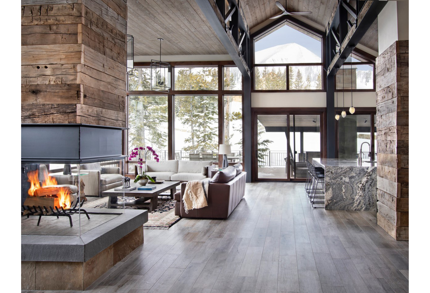 A living room with a fireplace and lots of windows