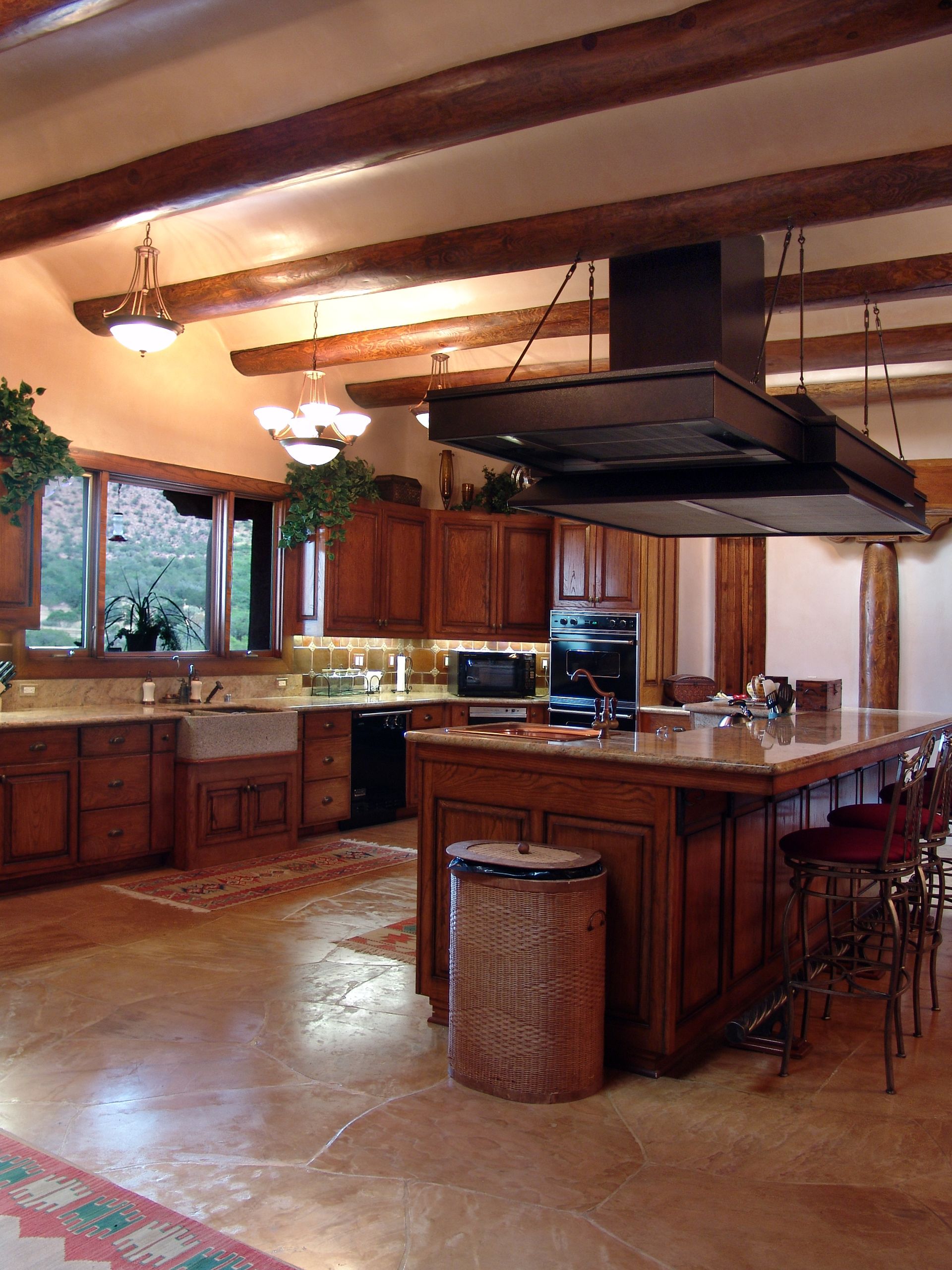 A kitchen with wooden cabinets and a large island