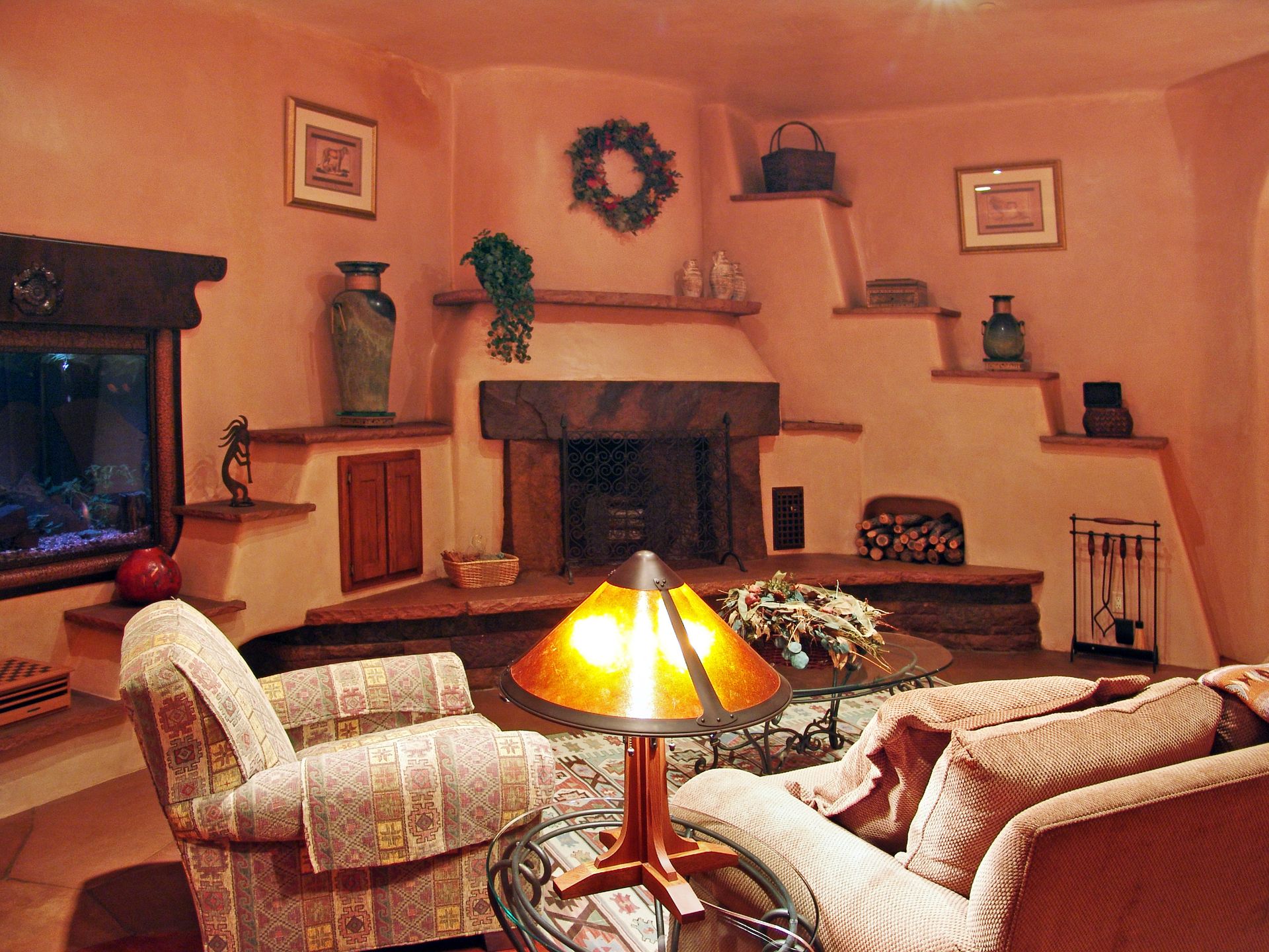 A living room with a fireplace and a lamp