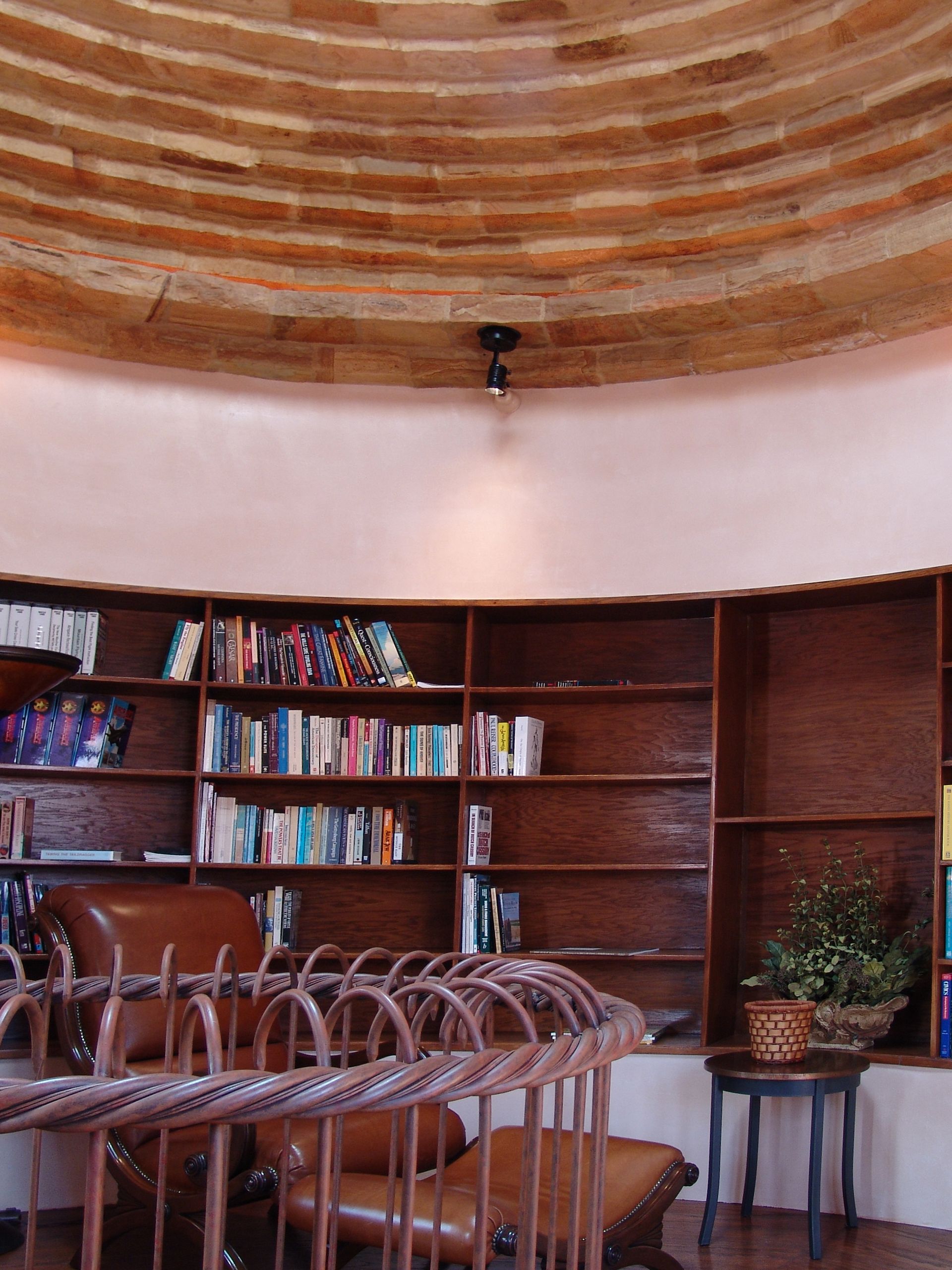 A room with a wooden ceiling and shelves filled with books