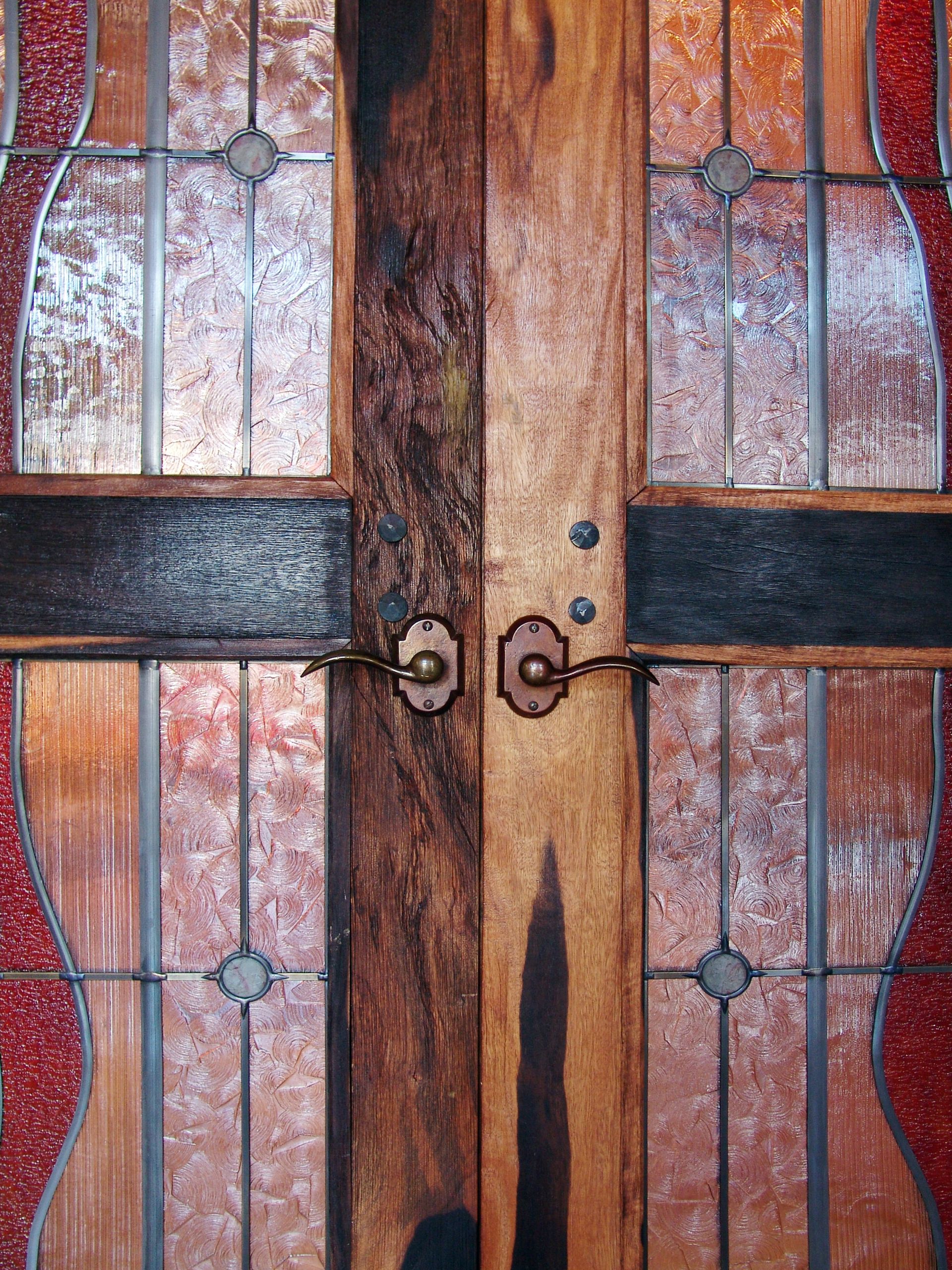 A wooden door with a stained glass design on it