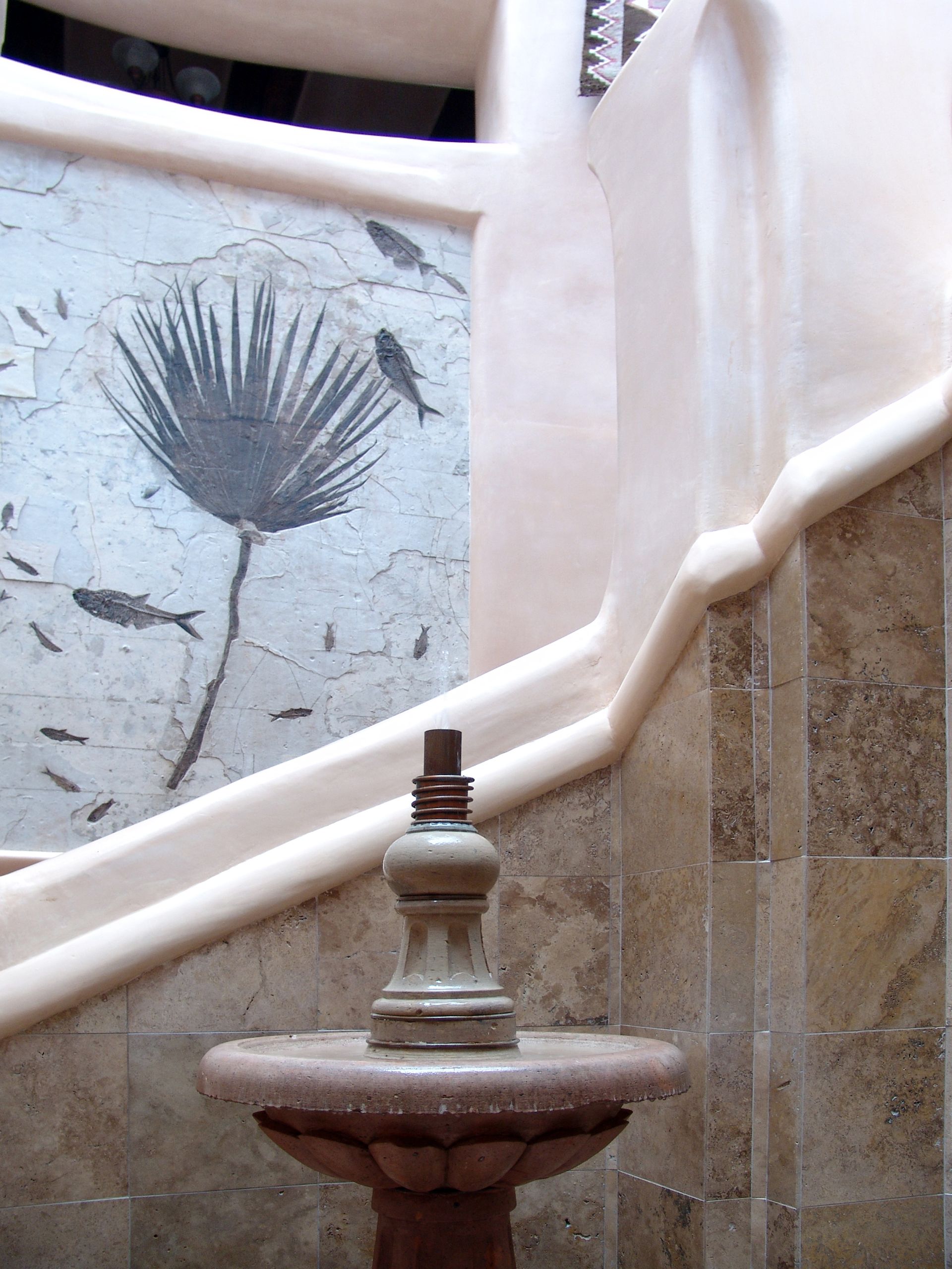 A staircase with a picture of a flower on the wall