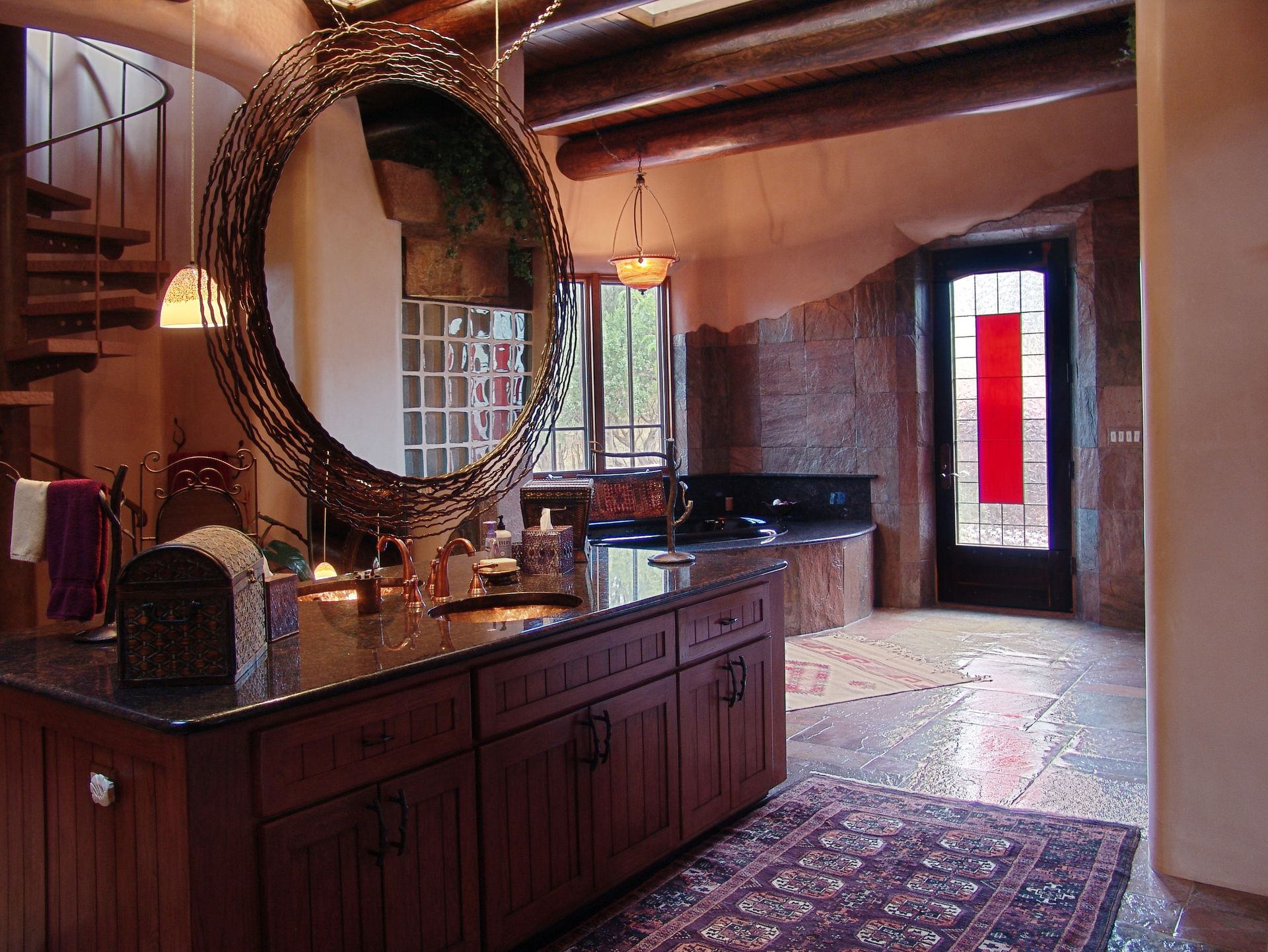A bathroom with a large round mirror on the wall