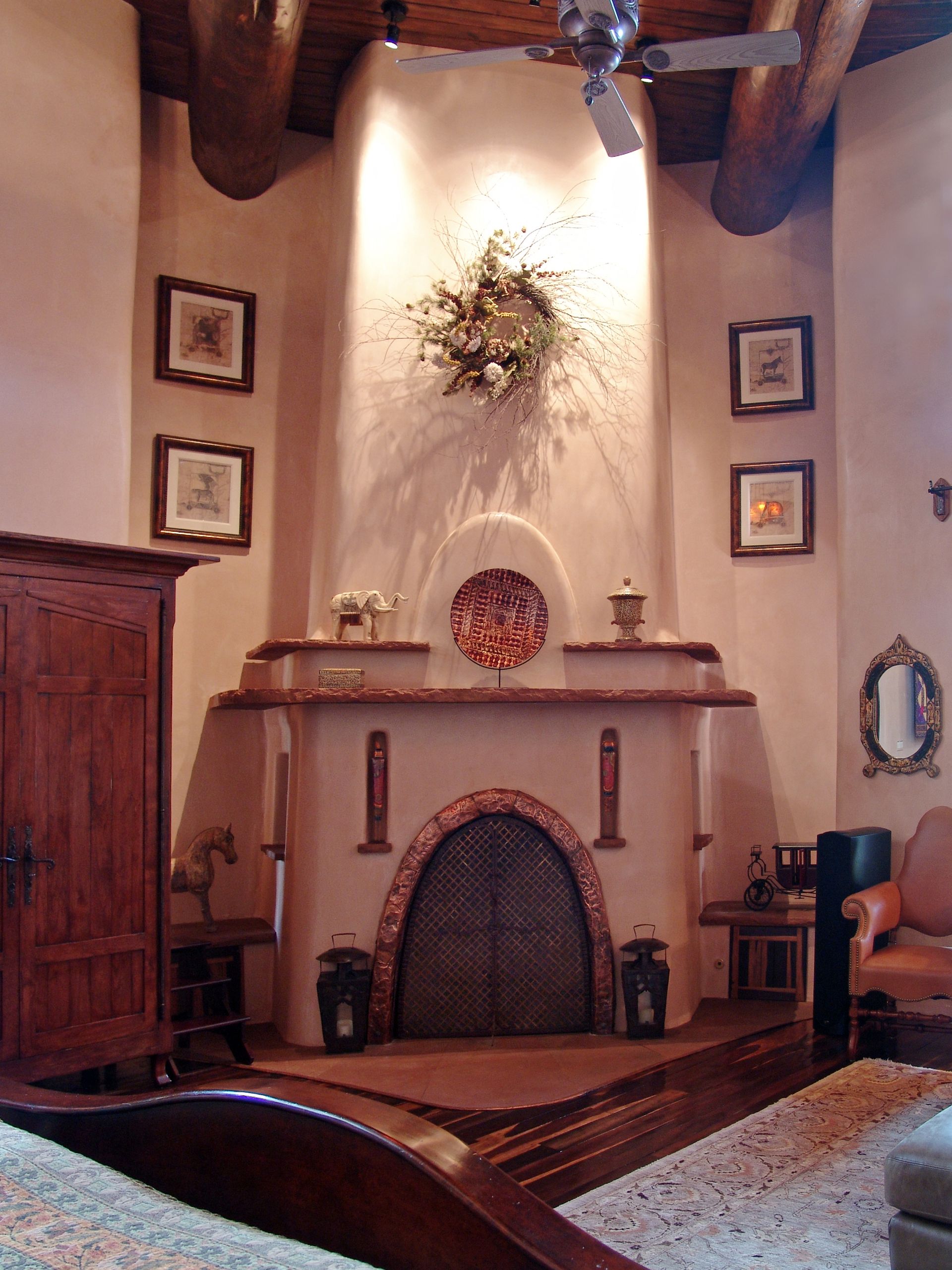 A living room with a fireplace and a ceiling fan