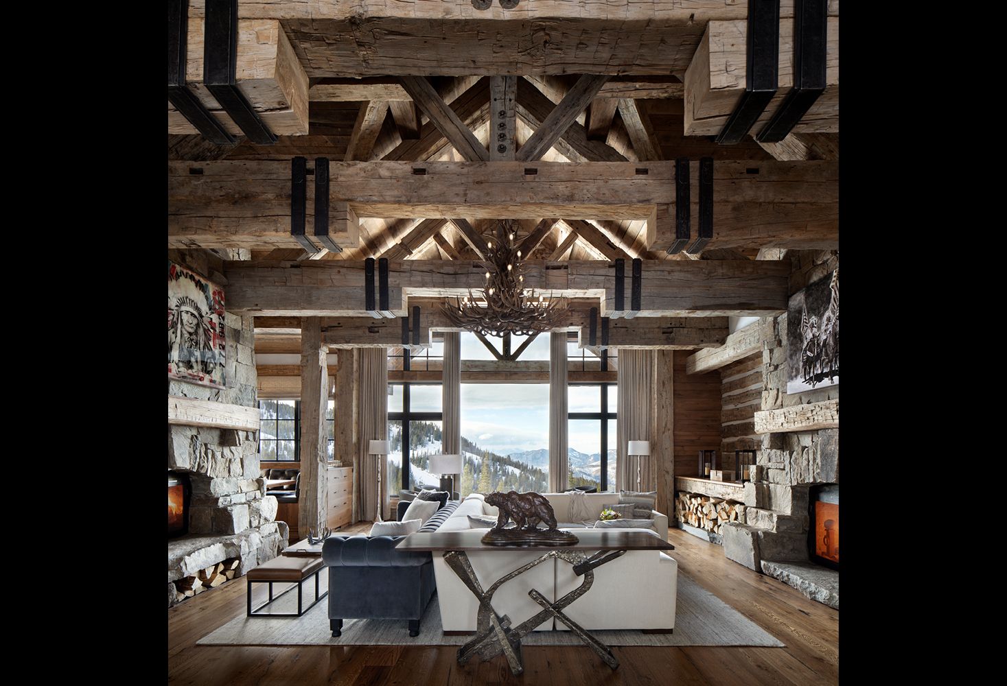 A living room filled with furniture and a fireplace in a log cabin.