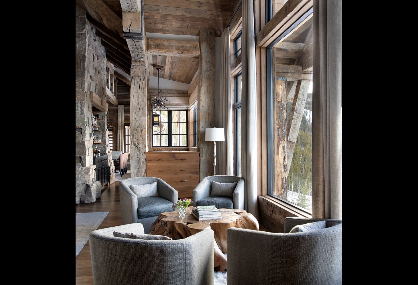 A living room filled with furniture and lots of windows.