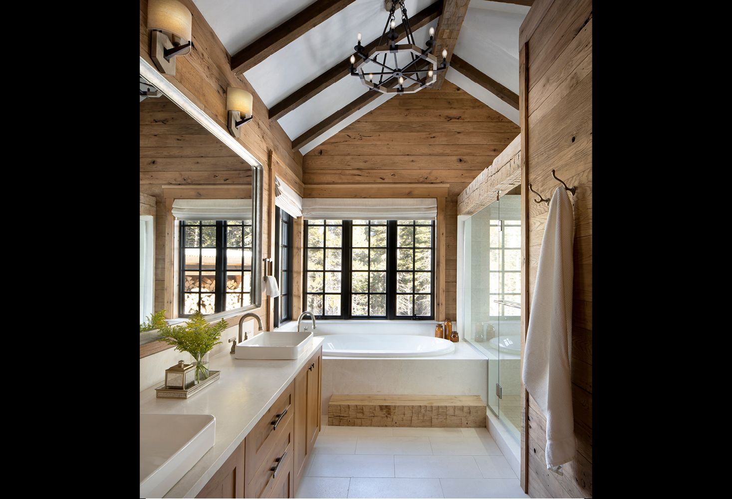 A bathroom with a bathtub and two sinks