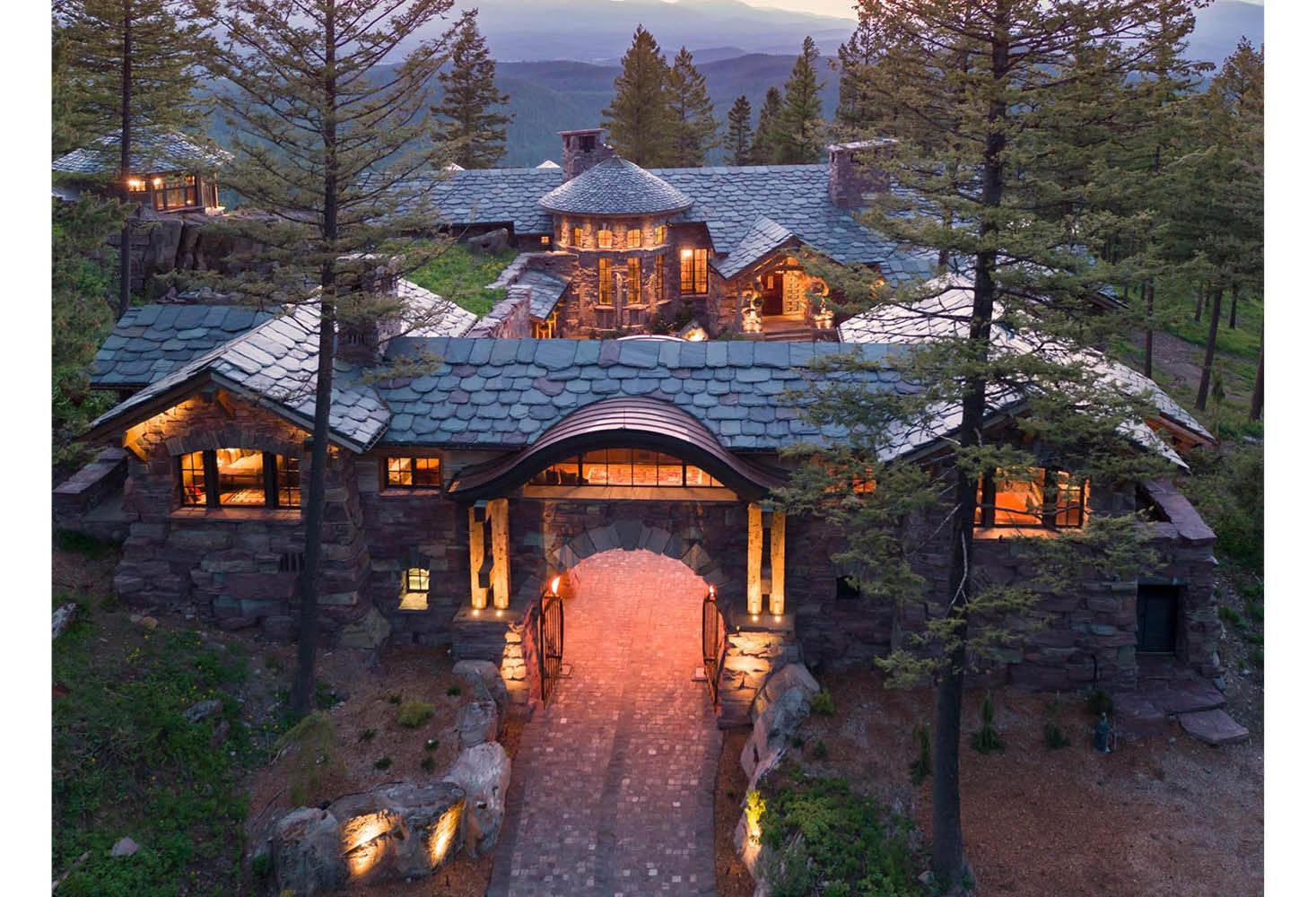 An aerial view of a large house surrounded by trees