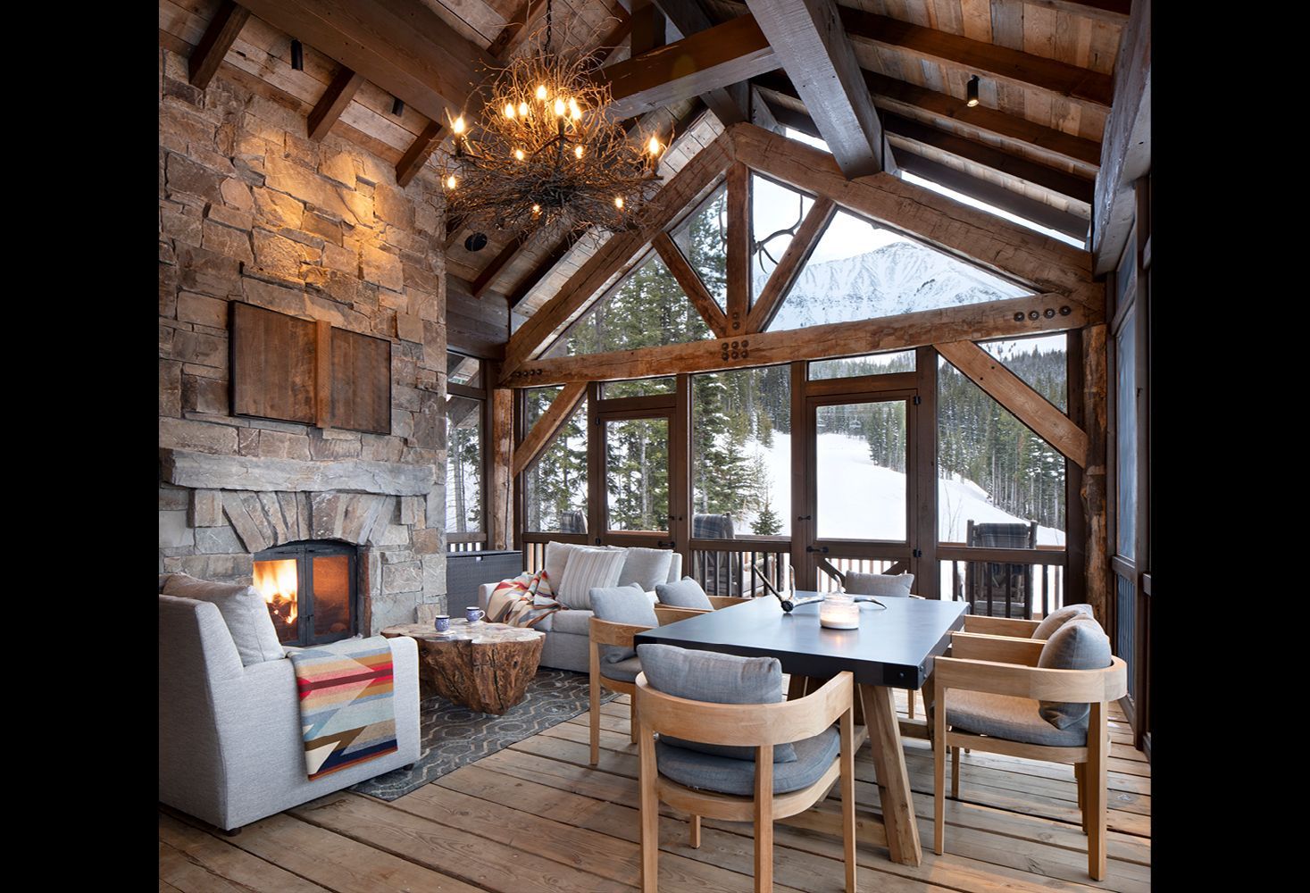 A living room with a fireplace and a table and chairs.