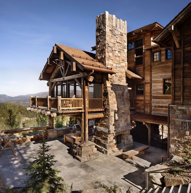 A large wooden house with a large stone chimney