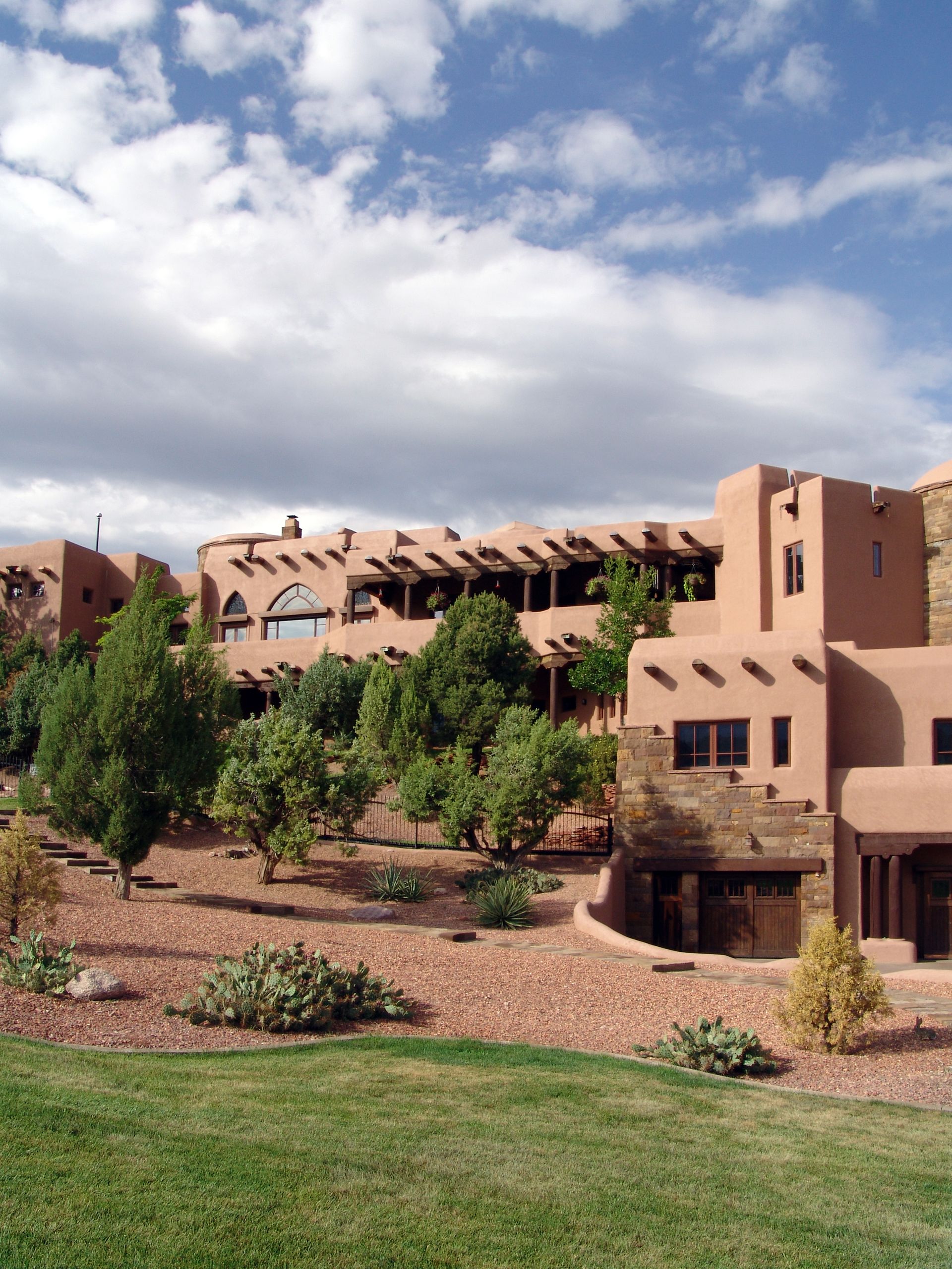 A large building with a lot of windows is surrounded by trees
