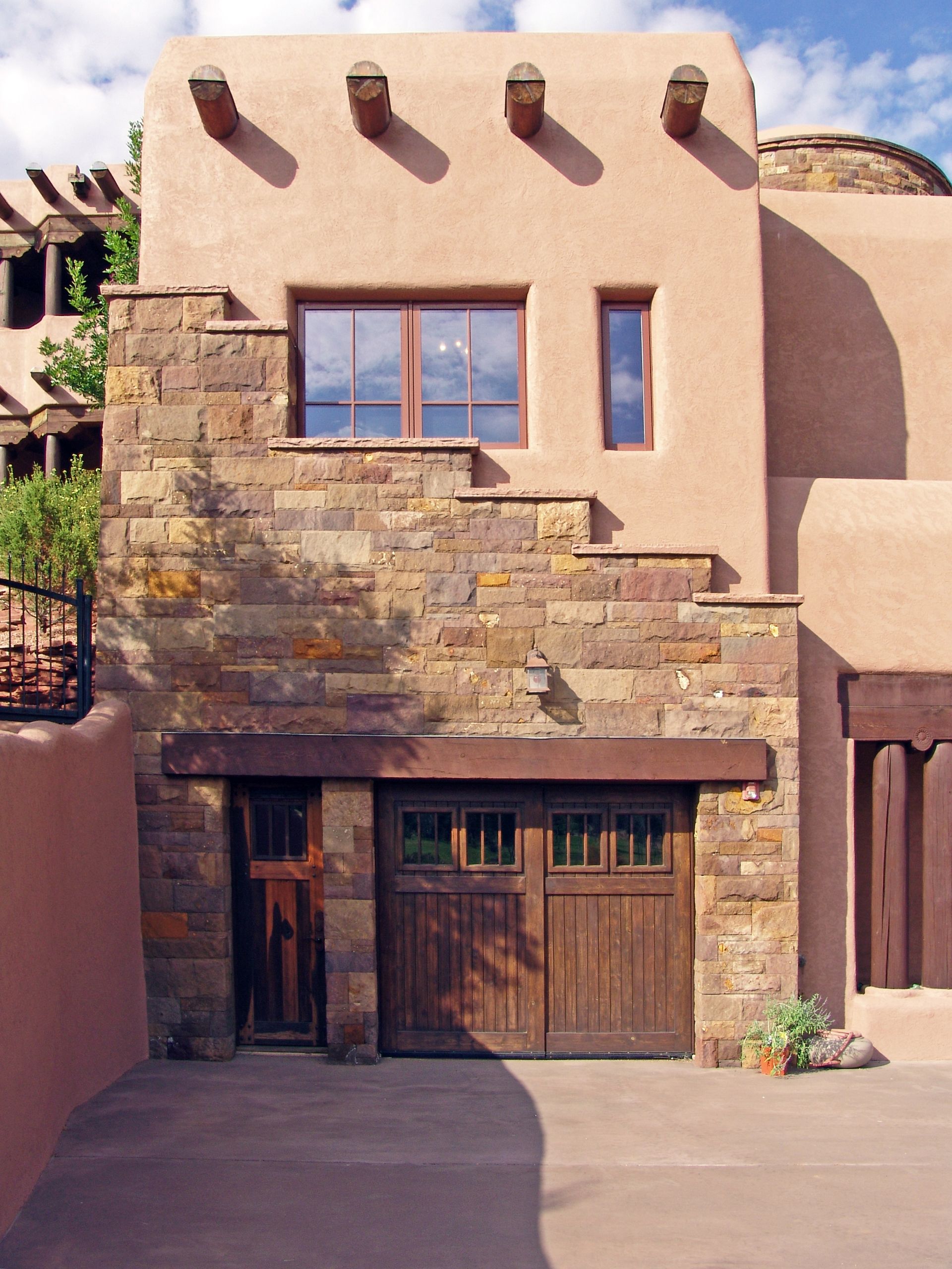 A brick building with a wooden garage door