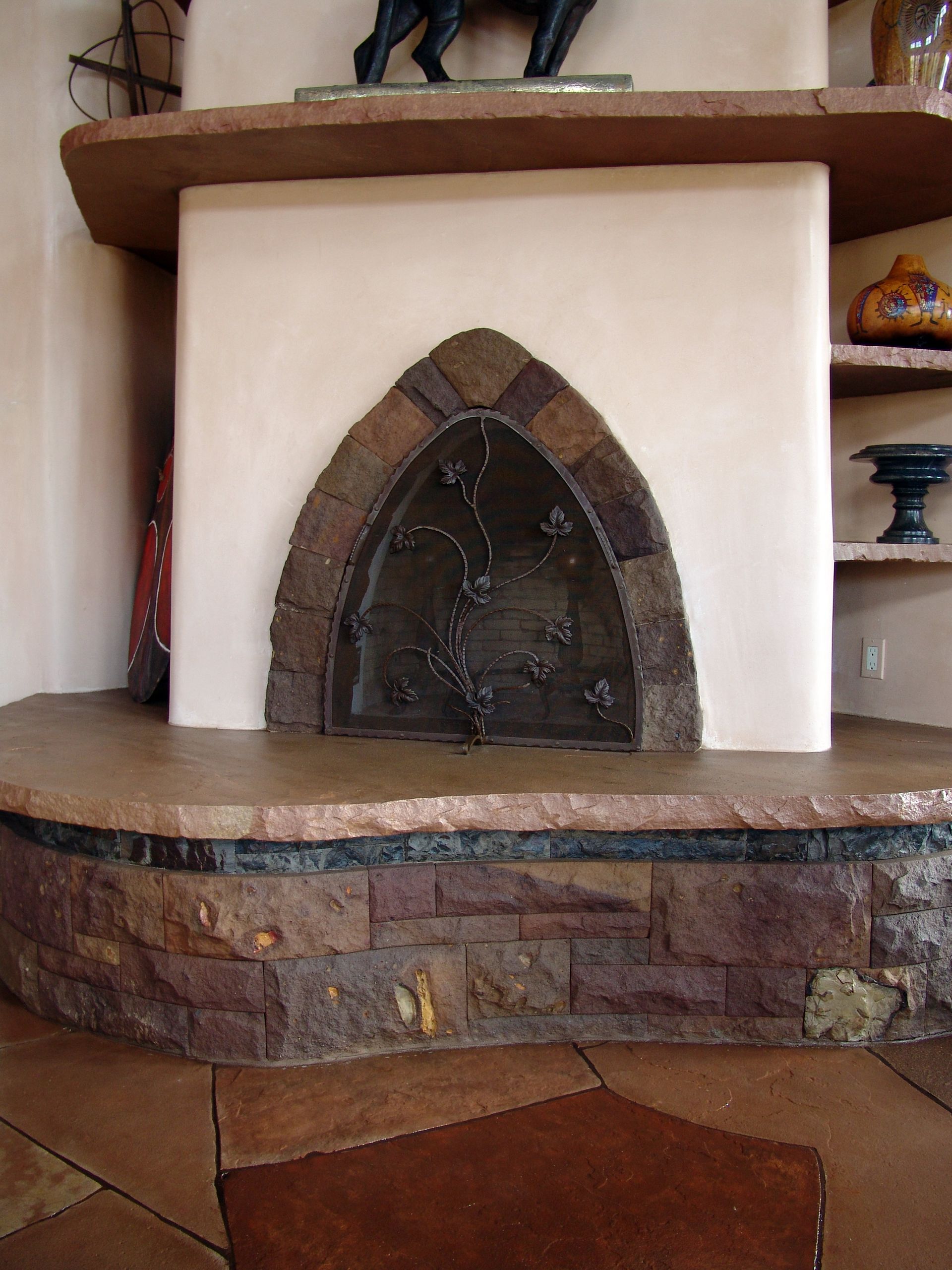A fireplace with a statue of a horse on top of it