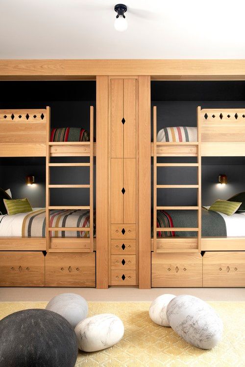 A room with bunk beds and rocks on the floor