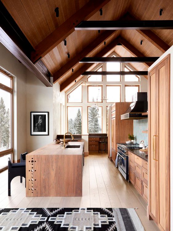 A kitchen with a vaulted ceiling and wooden cabinets