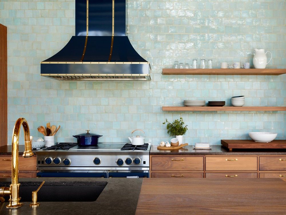 A kitchen with a stove top oven and a sink