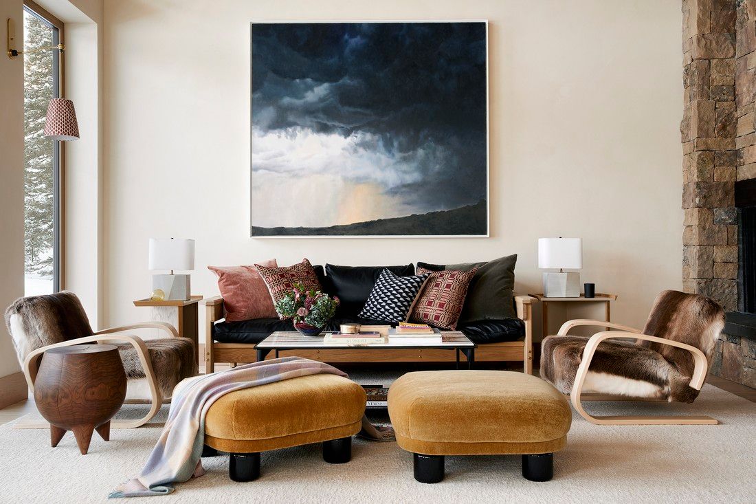 There is a painting on the wall above the couch in the living room.