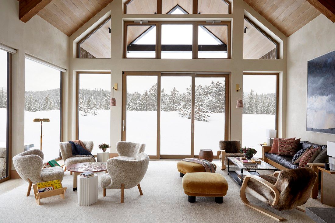 A living room filled with furniture and a lot of windows.