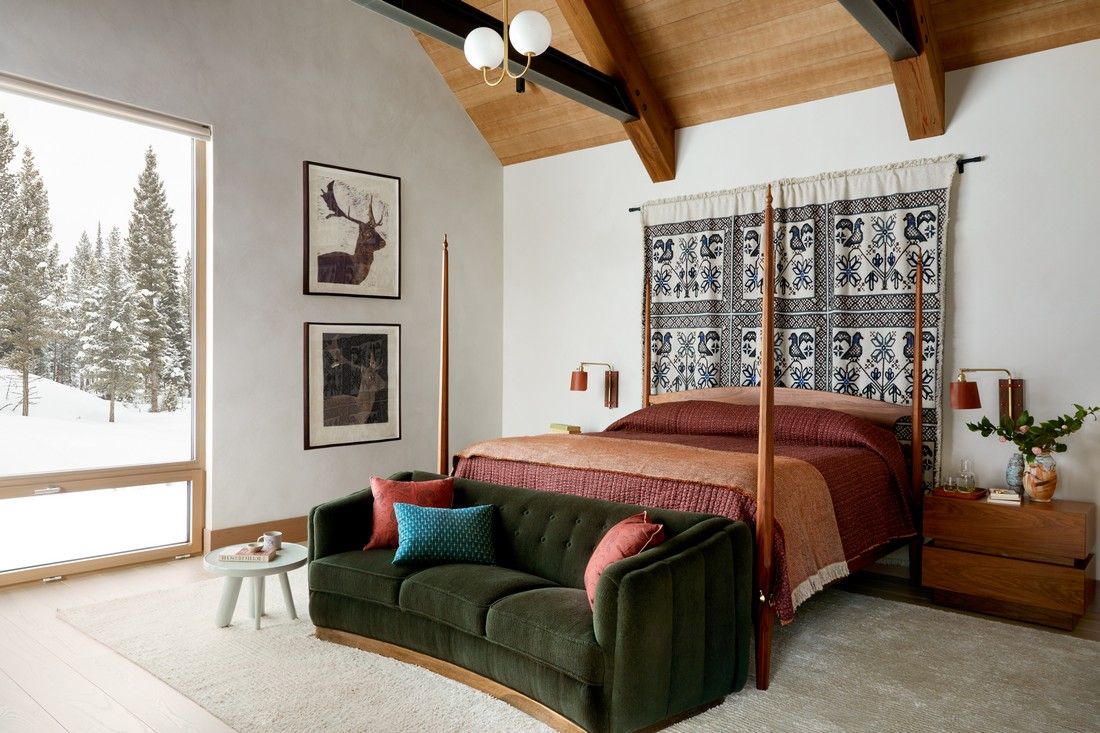 A bedroom with a four poster bed and a couch.