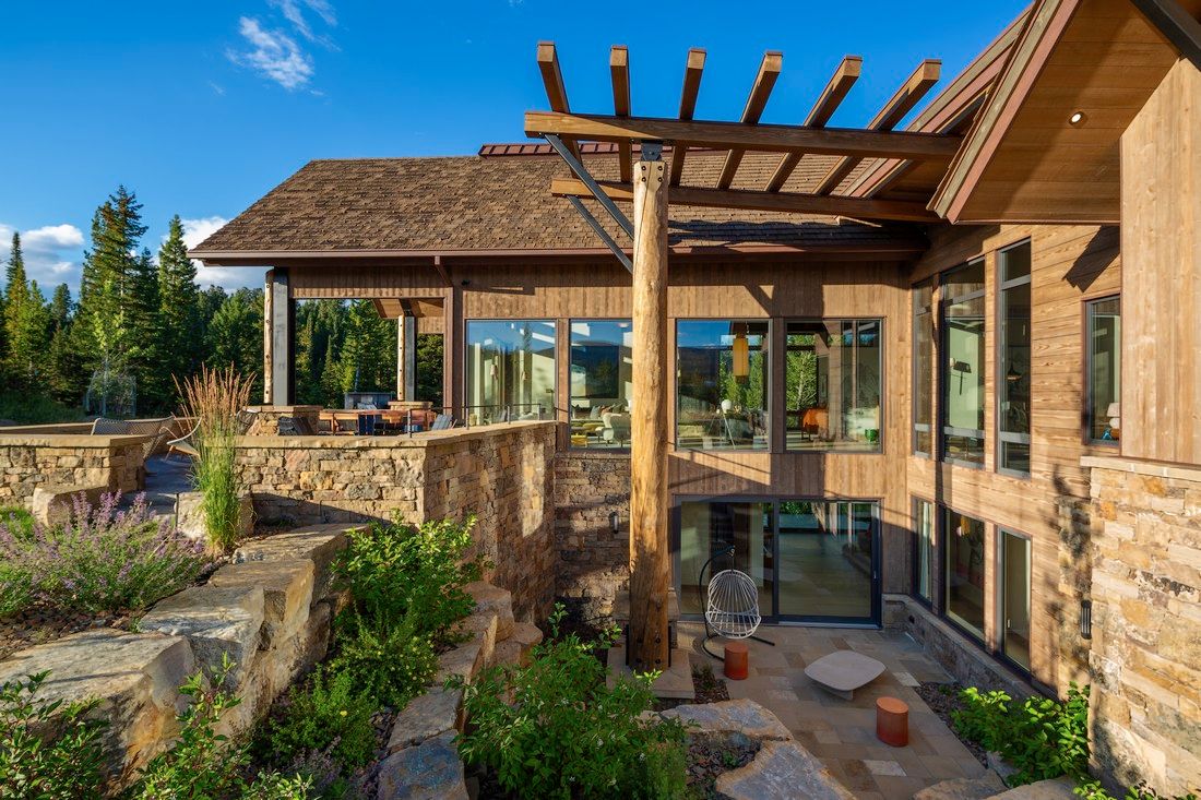 A large house with a lot of windows and a pergola.