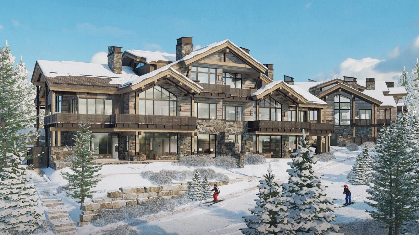 A large house with a lot of windows is surrounded by snow and trees.
