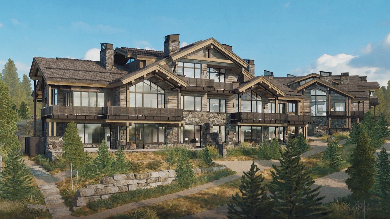 A large house is sitting on top of a hill surrounded by trees.