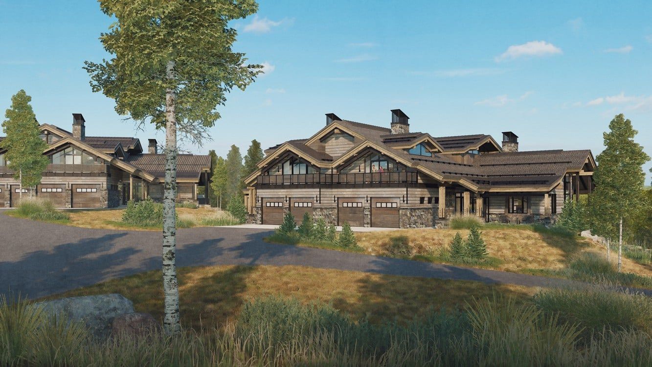 A large house is sitting on top of a hill next to a tree.