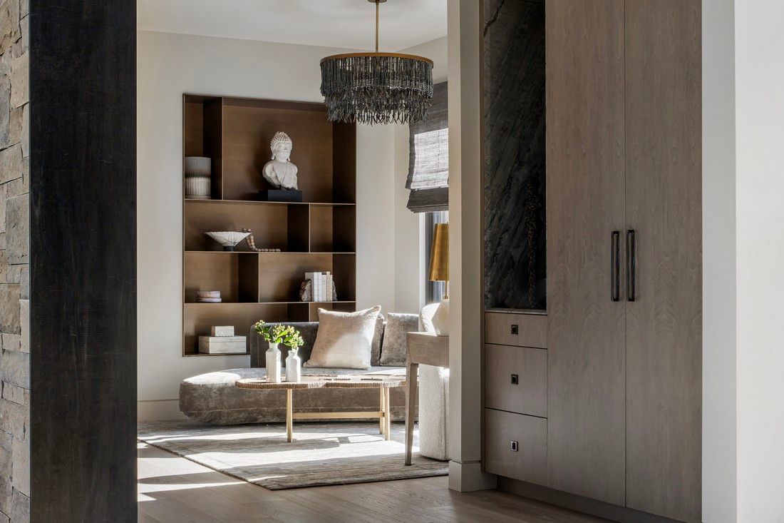 A living room with a couch , coffee table , and shelves.