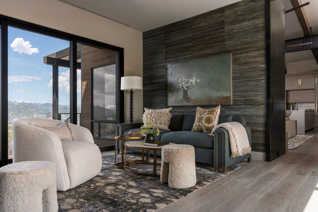 A living room with a couch , chairs , and a table.