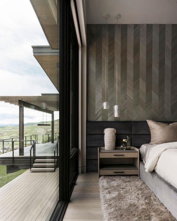 A bedroom with a large window and a bed