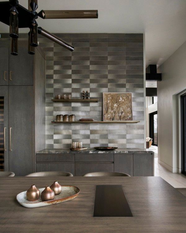A kitchen with a table and chairs and a painting on the wall.