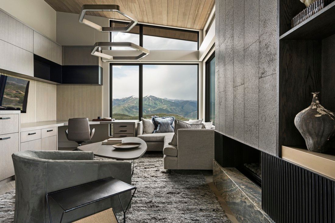 A living room with a lot of furniture and a large window.