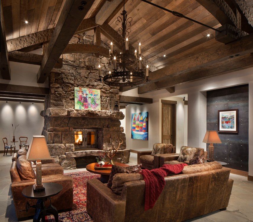 A living room filled with furniture and a stone fireplace