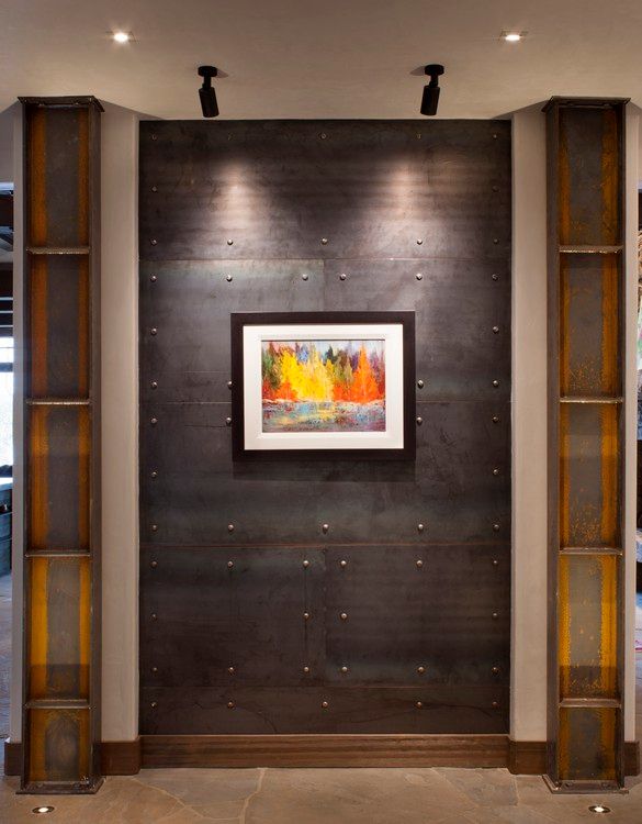 A picture is hanging on a wall next to shelves