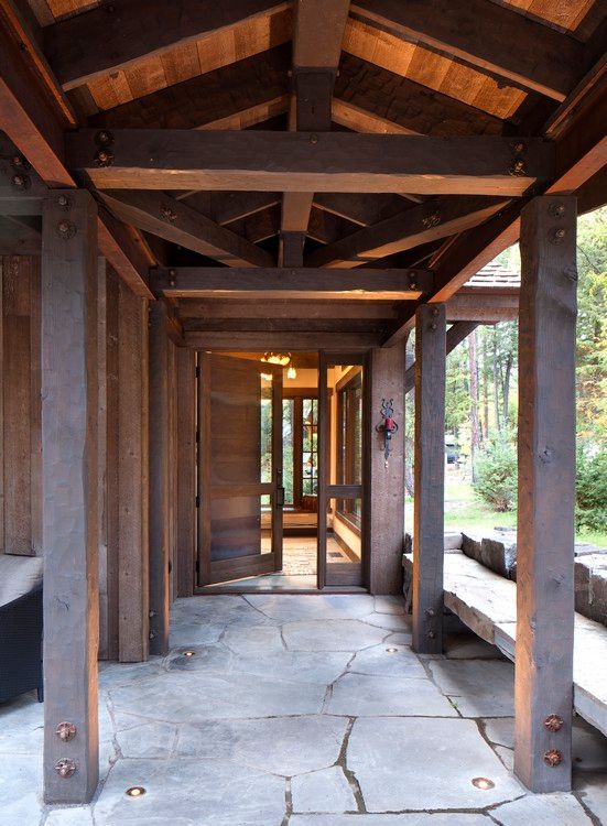 A wooden structure with a stone walkway leading to the door