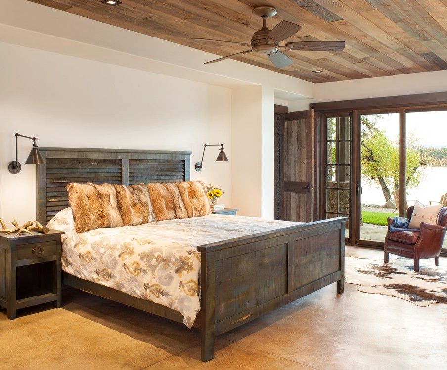 A bedroom with a large bed and a ceiling fan