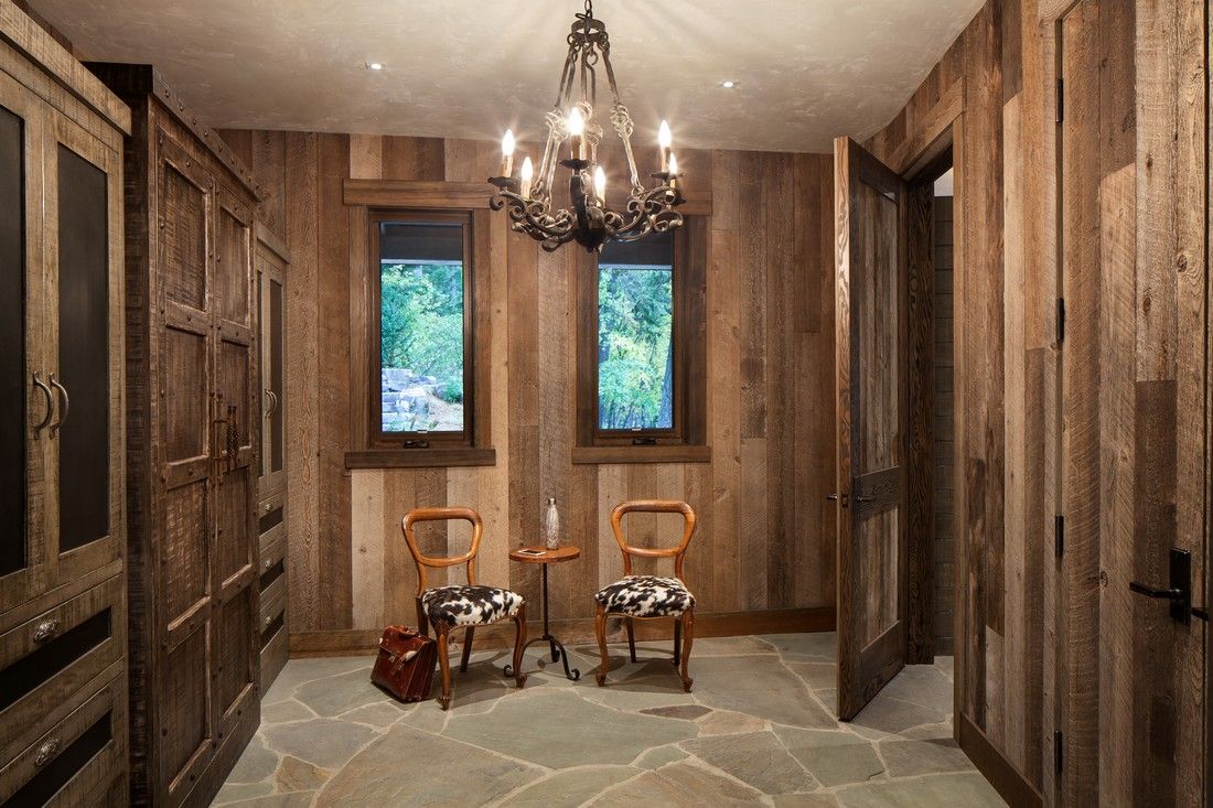 A room with wooden walls and a chandelier hanging from the ceiling.