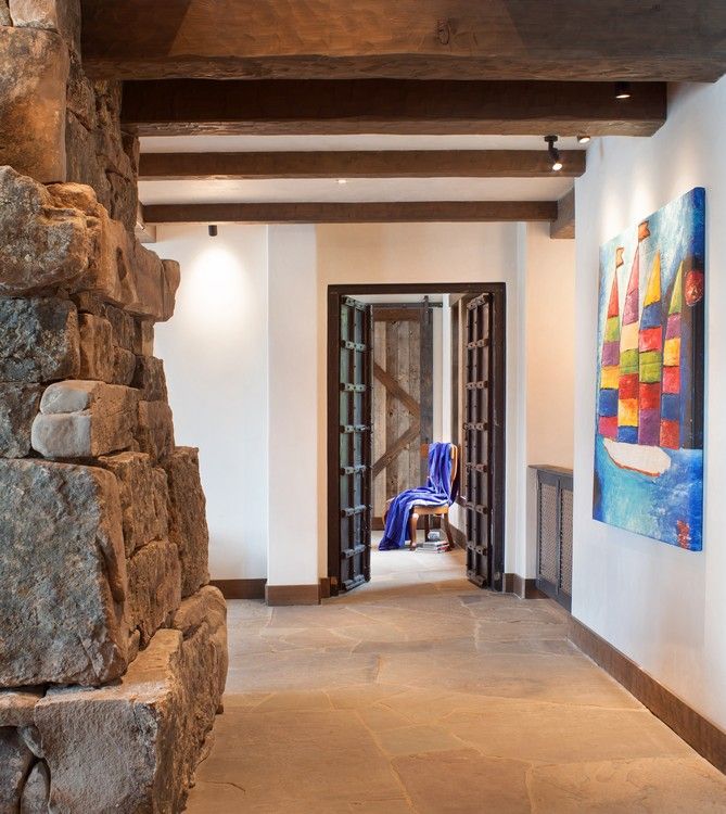 A hallway with a painting of sailboats on the wall