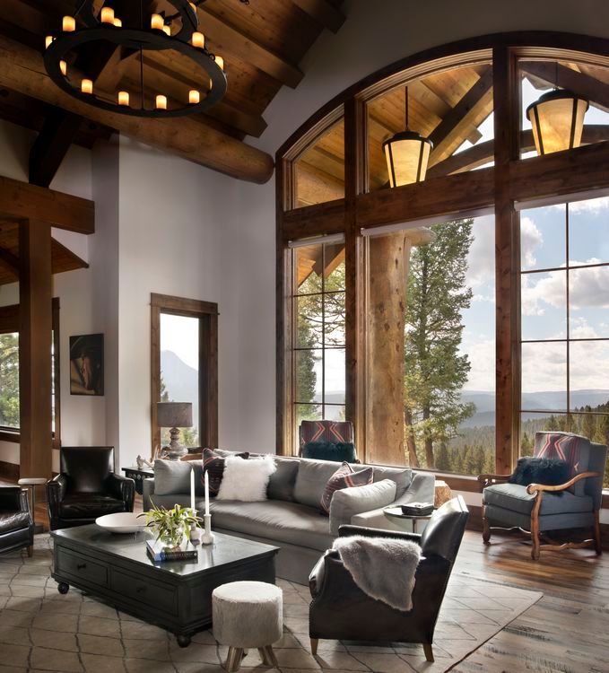 A living room with a lot of windows and furniture