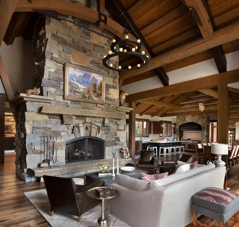 A living room with a stone fireplace and a couch