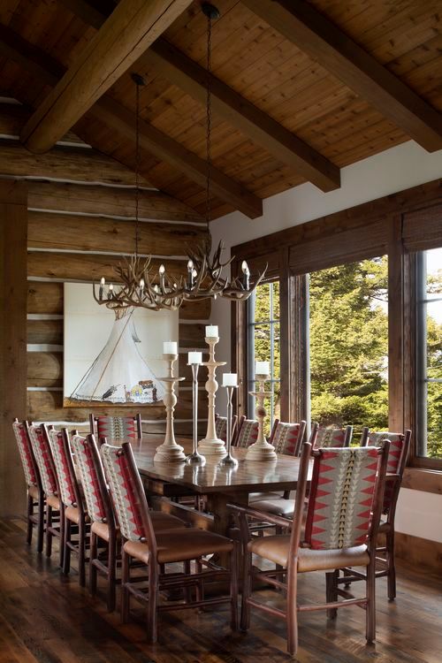 A dining room with a table and chairs and a chandelier