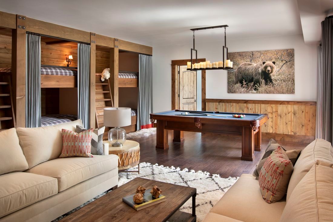 A living room with bunk beds and a pool table.