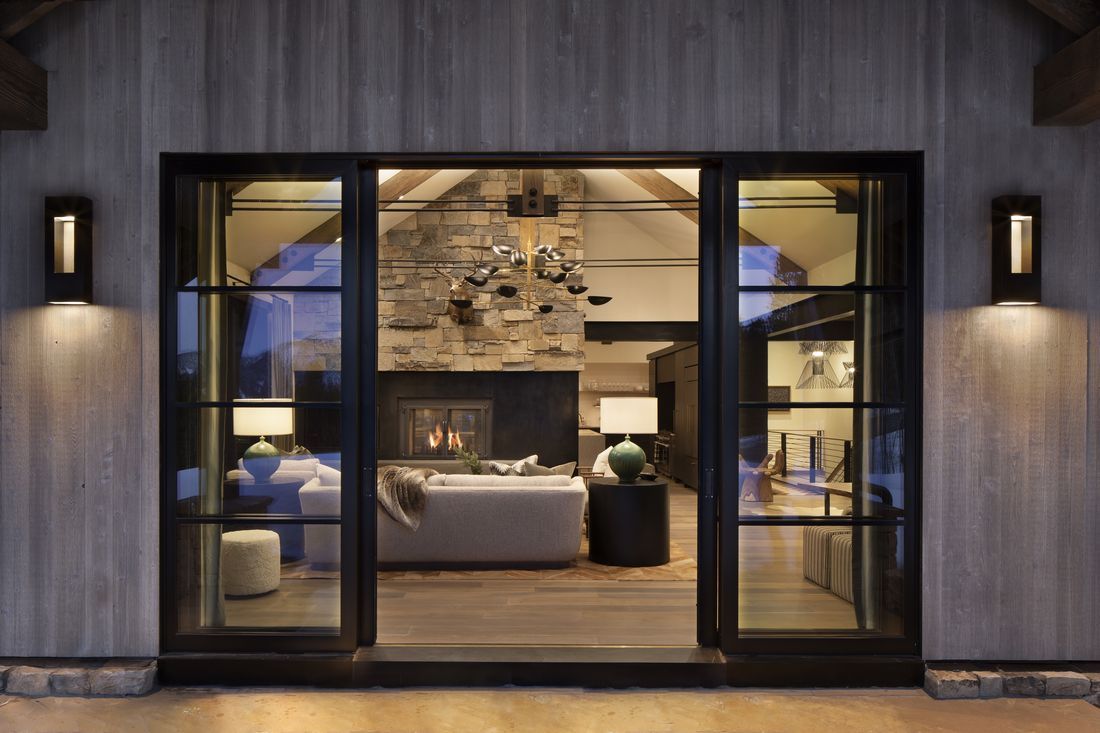 A living room with a fireplace and sliding glass doors