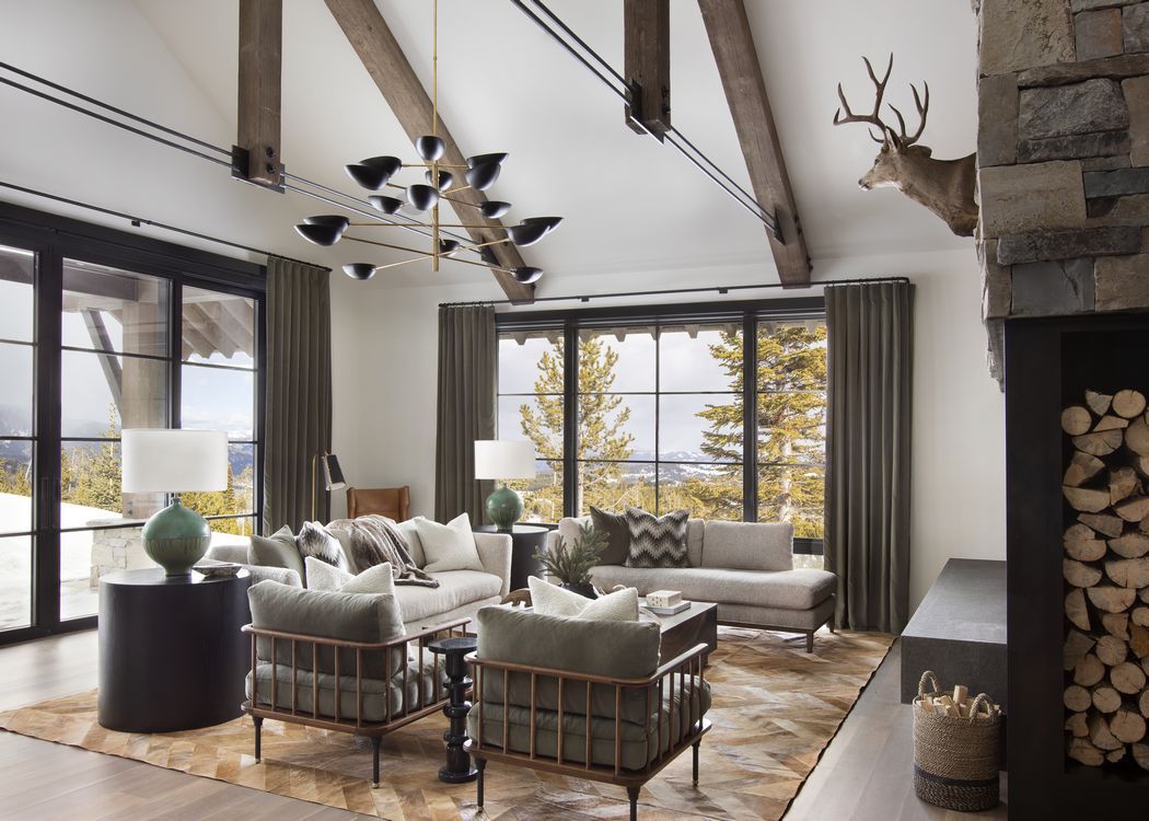 A living room with a couch , chairs , and a fireplace.