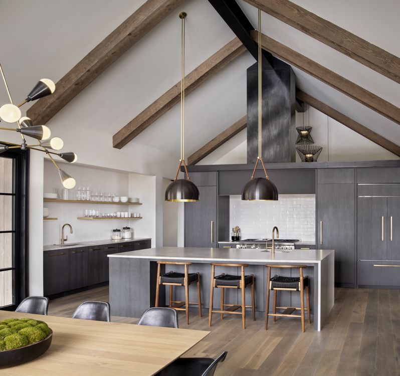 A kitchen with a large island and stools