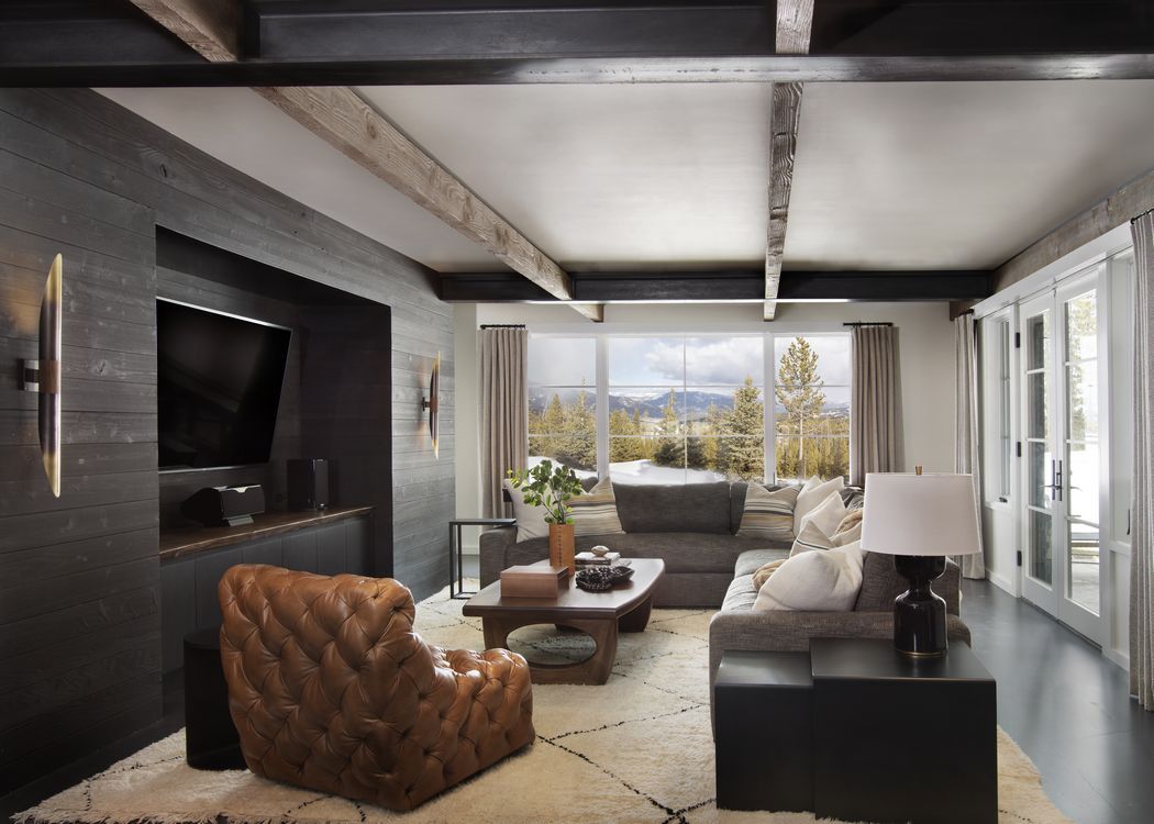 A living room with a couch , chair , coffee table and television