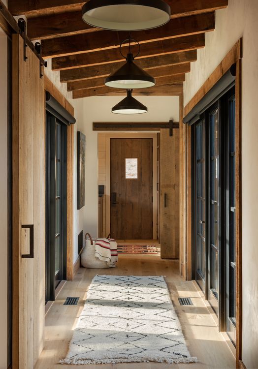 A hallway in a house with a rug on the floor